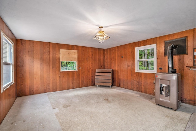 4348 S Grandview Hwy, Harrietta, MI 49638 - unfurnished room with wooden walls and a wood stove