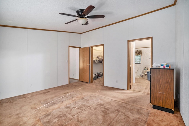 4348 S Grandview Hwy, Harrietta, MI 49638 - unfurnished bedroom with ensuite bathroom, a walk in closet, light colored carpet, ceiling fan, and crown molding