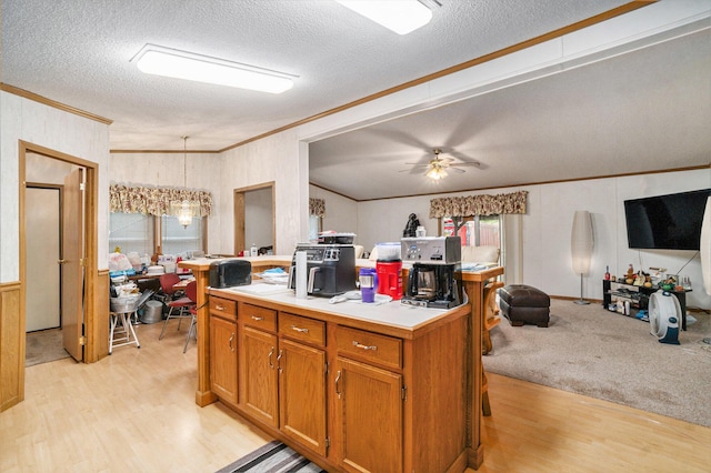 4348 S Grandview Hwy, Harrietta, MI 49638 - kitchen featuring crown molding, decorative light fixtures, a center island, and light hardwood / wood-style floors