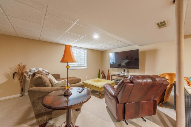 carpeted living room featuring a paneled ceiling