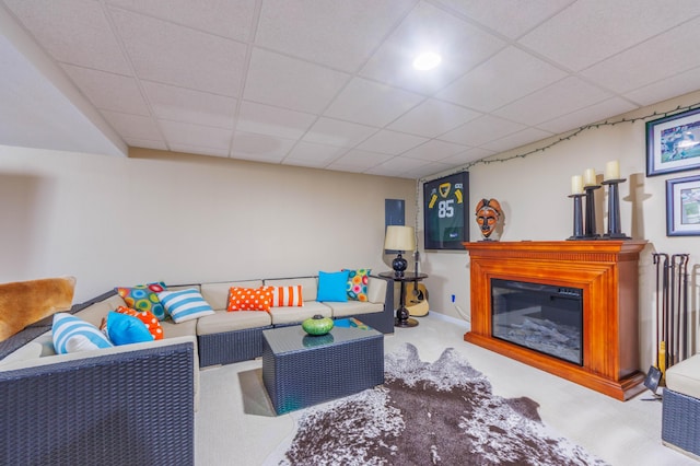 carpeted living room with a paneled ceiling