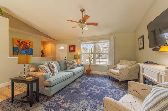 living room featuring vaulted ceiling, hardwood / wood-style floors, and ceiling fan