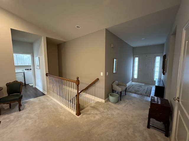 hall featuring washer / clothes dryer and carpet floors