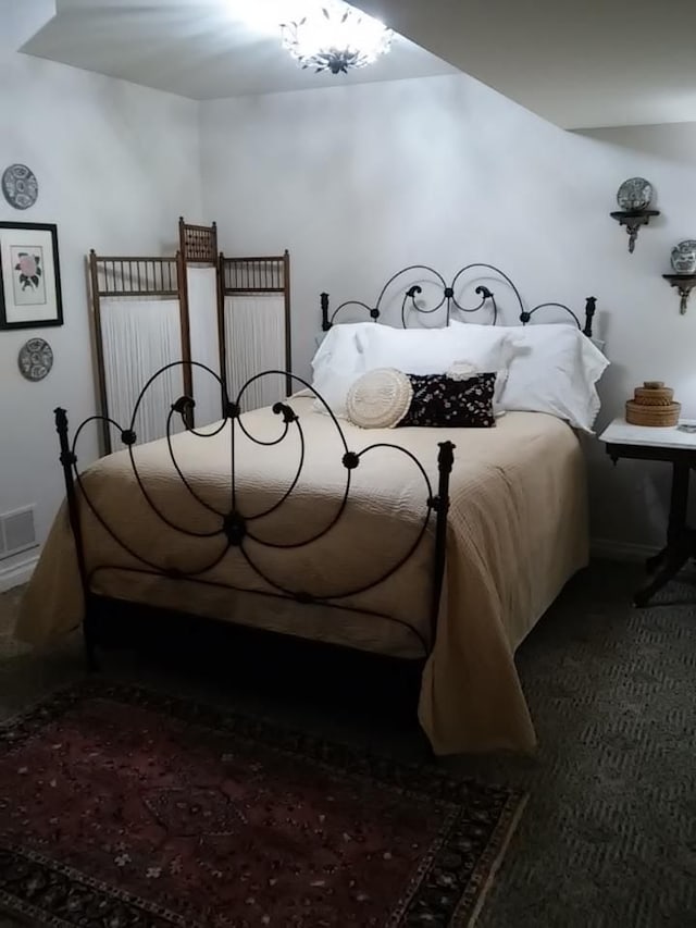 bedroom with dark colored carpet