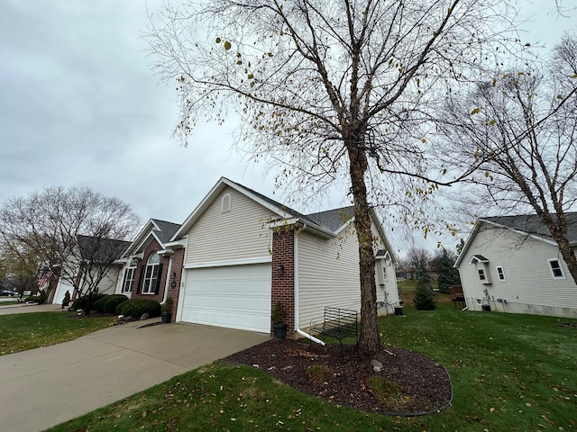 view of property exterior with a garage and a lawn