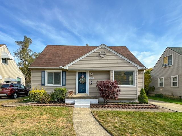 bungalow-style house featuring a front yard