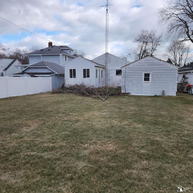 rear view of house featuring a lawn