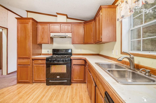 kitchen with lofted ceiling, sink, black gas stove, a textured ceiling, and light hardwood / wood-style flooring