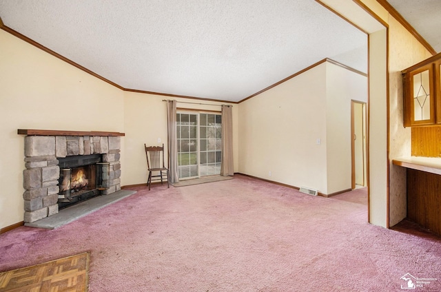 unfurnished living room featuring crown molding, a stone fireplace, carpet floors, and a textured ceiling