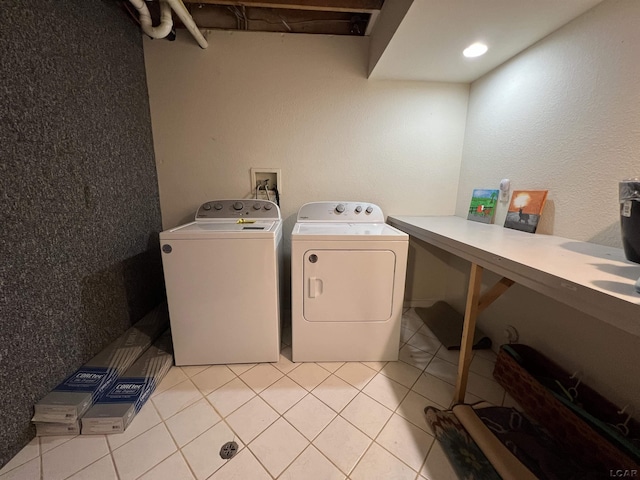 laundry area featuring light tile patterned flooring and separate washer and dryer