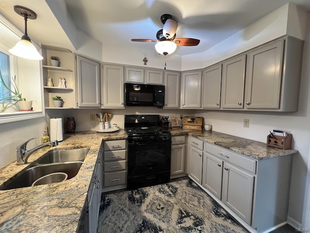 kitchen featuring sink, gray cabinetry, decorative light fixtures, light stone countertops, and black appliances