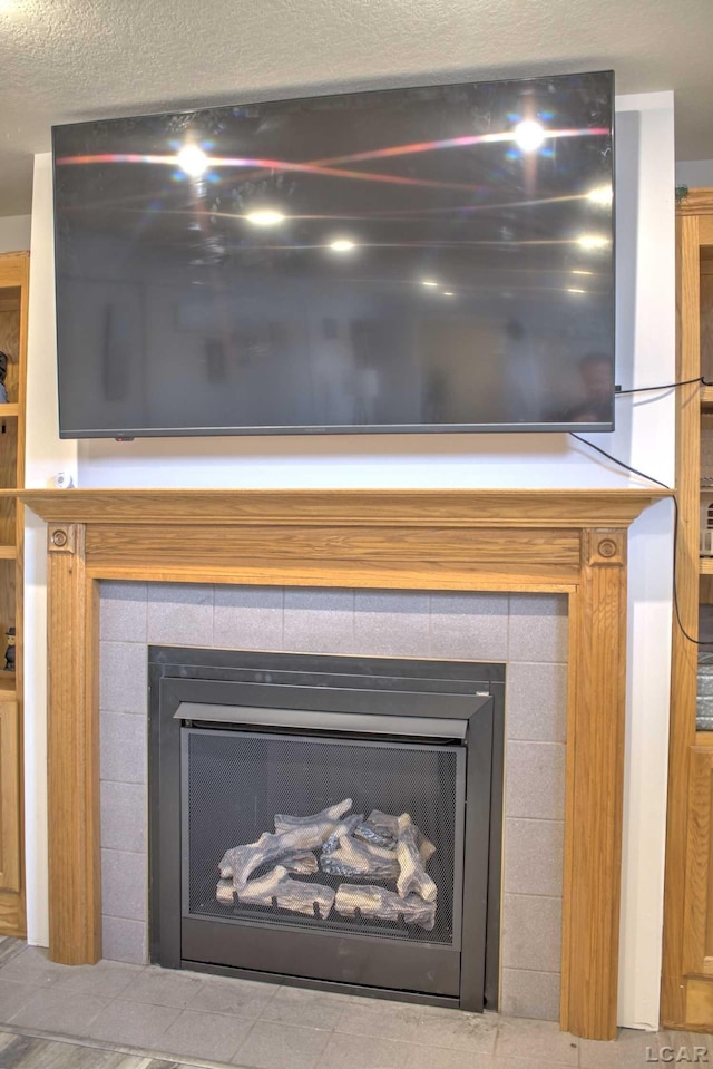 details featuring a fireplace and a textured ceiling