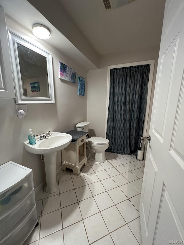 bathroom featuring tile patterned floors and toilet