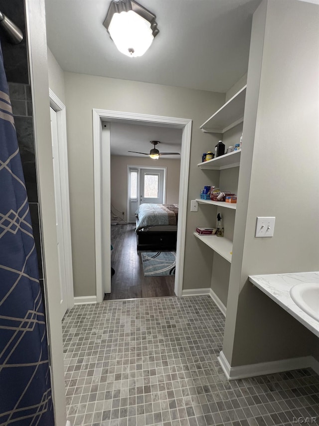 bathroom with ceiling fan and sink