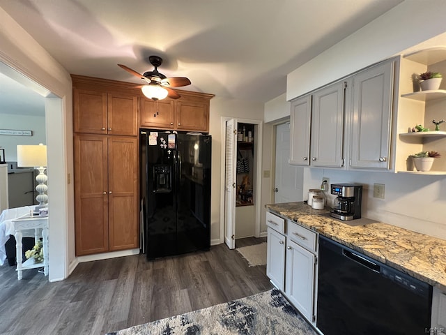 kitchen featuring white cabinetry, ceiling fan, black appliances, light stone countertops, and dark wood-type flooring