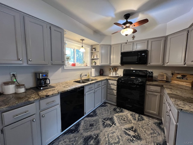 kitchen with sink, gray cabinetry, decorative light fixtures, ceiling fan, and black appliances