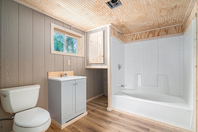 full bathroom with wood ceiling, hardwood / wood-style floors, vanity, shower / bathtub combination, and toilet