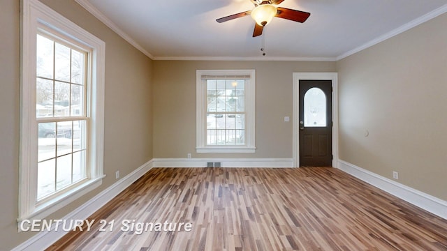 foyer with hardwood / wood-style flooring, ceiling fan, and ornamental molding