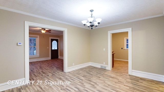 unfurnished room featuring an inviting chandelier, ornamental molding, and light hardwood / wood-style floors