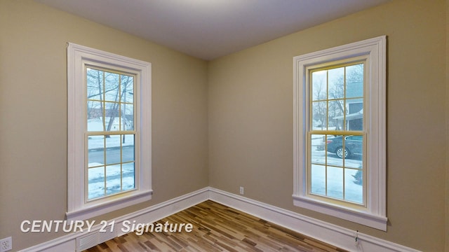 unfurnished room featuring hardwood / wood-style flooring