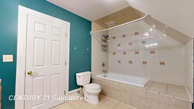 bathroom with tiled shower / bath combo, tile patterned flooring, and toilet