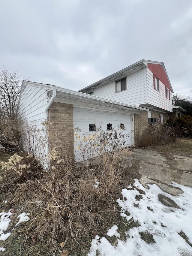 snow covered property featuring a garage