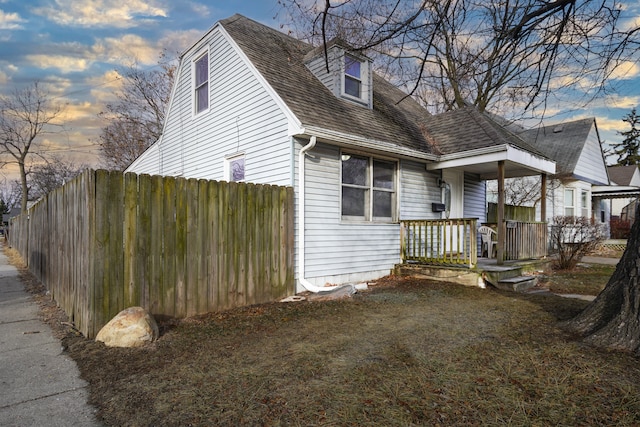 property exterior at dusk with a yard