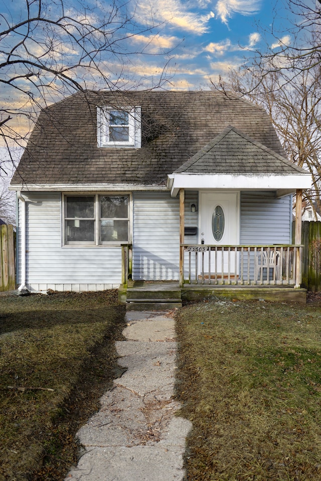 view of front of property with a front yard and covered porch