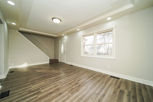 interior space featuring crown molding and dark wood-type flooring