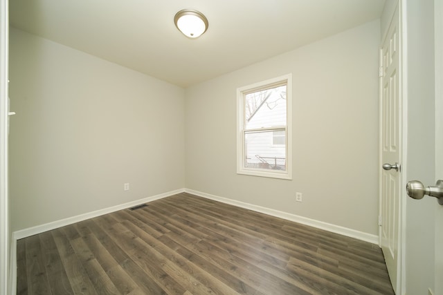 unfurnished room featuring dark hardwood / wood-style floors