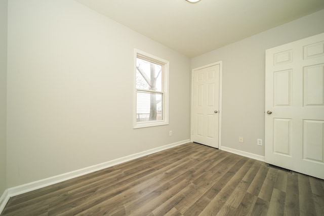 unfurnished bedroom featuring dark hardwood / wood-style flooring