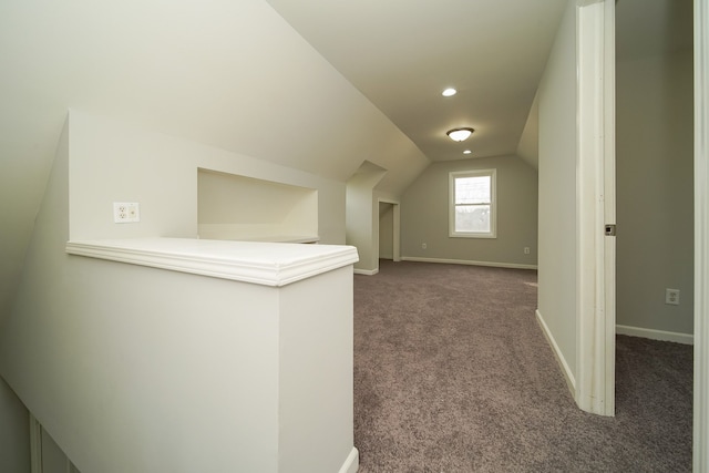 additional living space with lofted ceiling and dark carpet