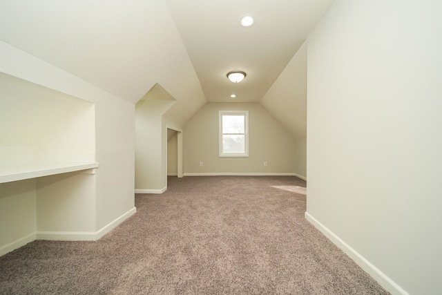 bonus room featuring light carpet and lofted ceiling