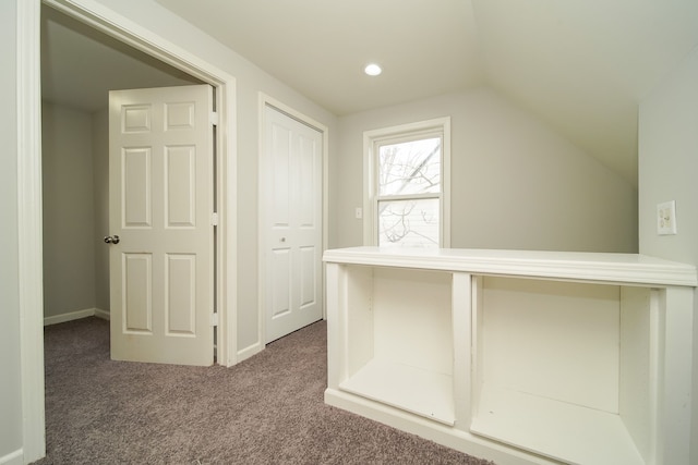 hall featuring vaulted ceiling and carpet floors