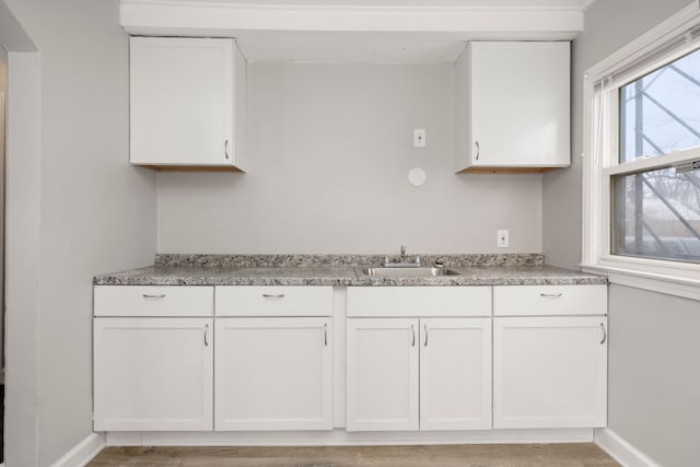 kitchen with white cabinetry and sink