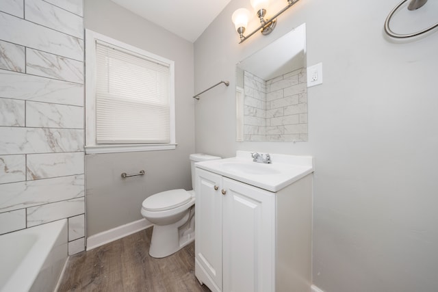 bathroom featuring hardwood / wood-style flooring, vanity, and toilet