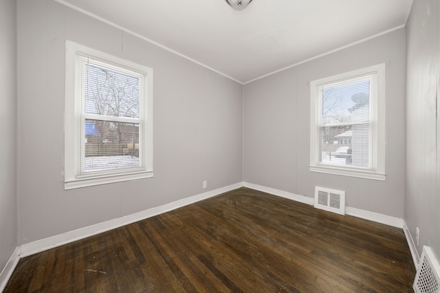 bonus room featuring dark wood-type flooring and plenty of natural light