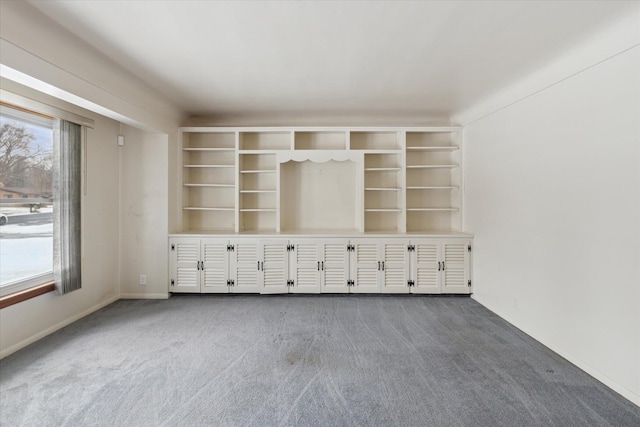 unfurnished living room with dark colored carpet