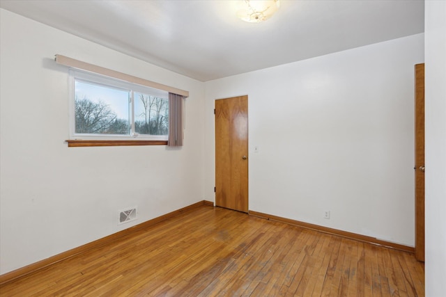 spare room with hardwood / wood-style flooring