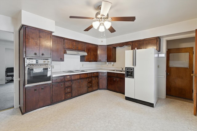 kitchen with electric cooktop, sink, oven, white refrigerator with ice dispenser, and dark brown cabinetry