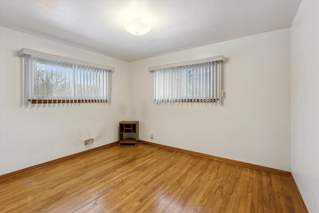 spare room featuring wood-type flooring