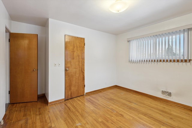 unfurnished bedroom featuring hardwood / wood-style flooring