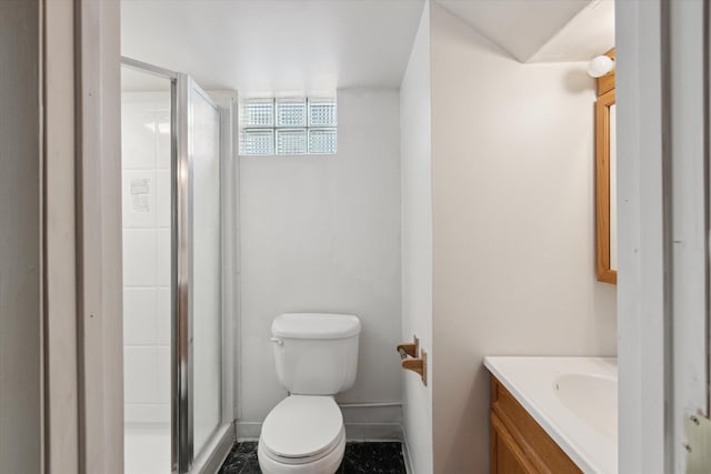 bathroom featuring a shower with door, vanity, and toilet