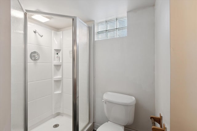 bathroom featuring walk in shower and toilet