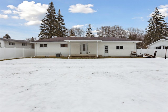 snow covered house featuring central AC unit