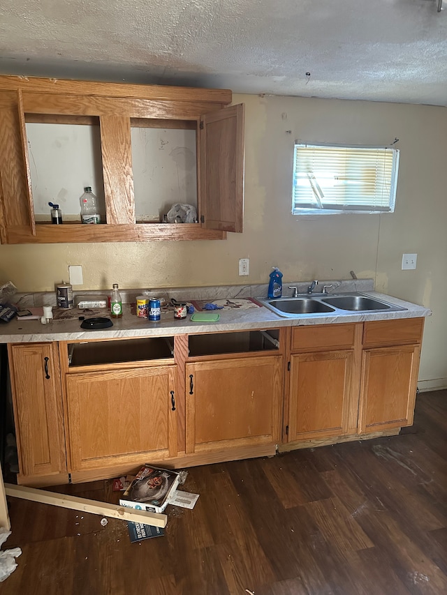 kitchen with dark hardwood / wood-style flooring, sink, and a textured ceiling