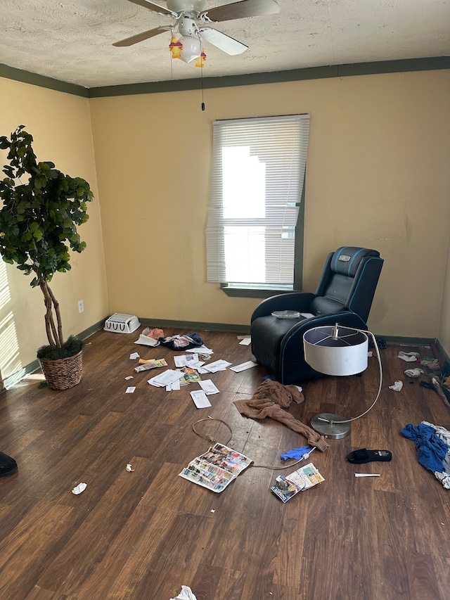 sitting room featuring hardwood / wood-style flooring, ceiling fan, and a textured ceiling