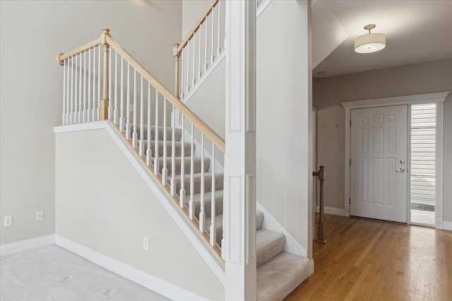 staircase with hardwood / wood-style flooring