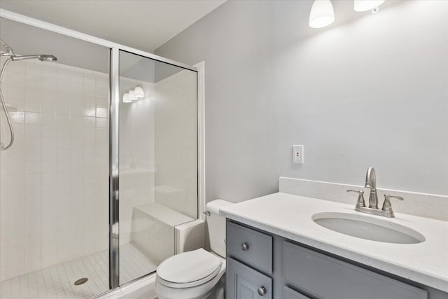 bathroom with vanity, an enclosed shower, and toilet