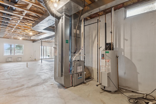 basement featuring heating unit and water heater